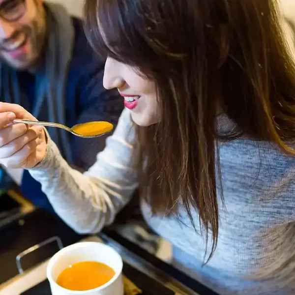 Two people in an office enjoying healthy and nutritious soup from The Little Gourmet.