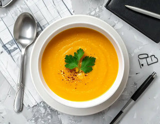  bowl of Chai roasted pumpkin soup with garnish on a marble surface