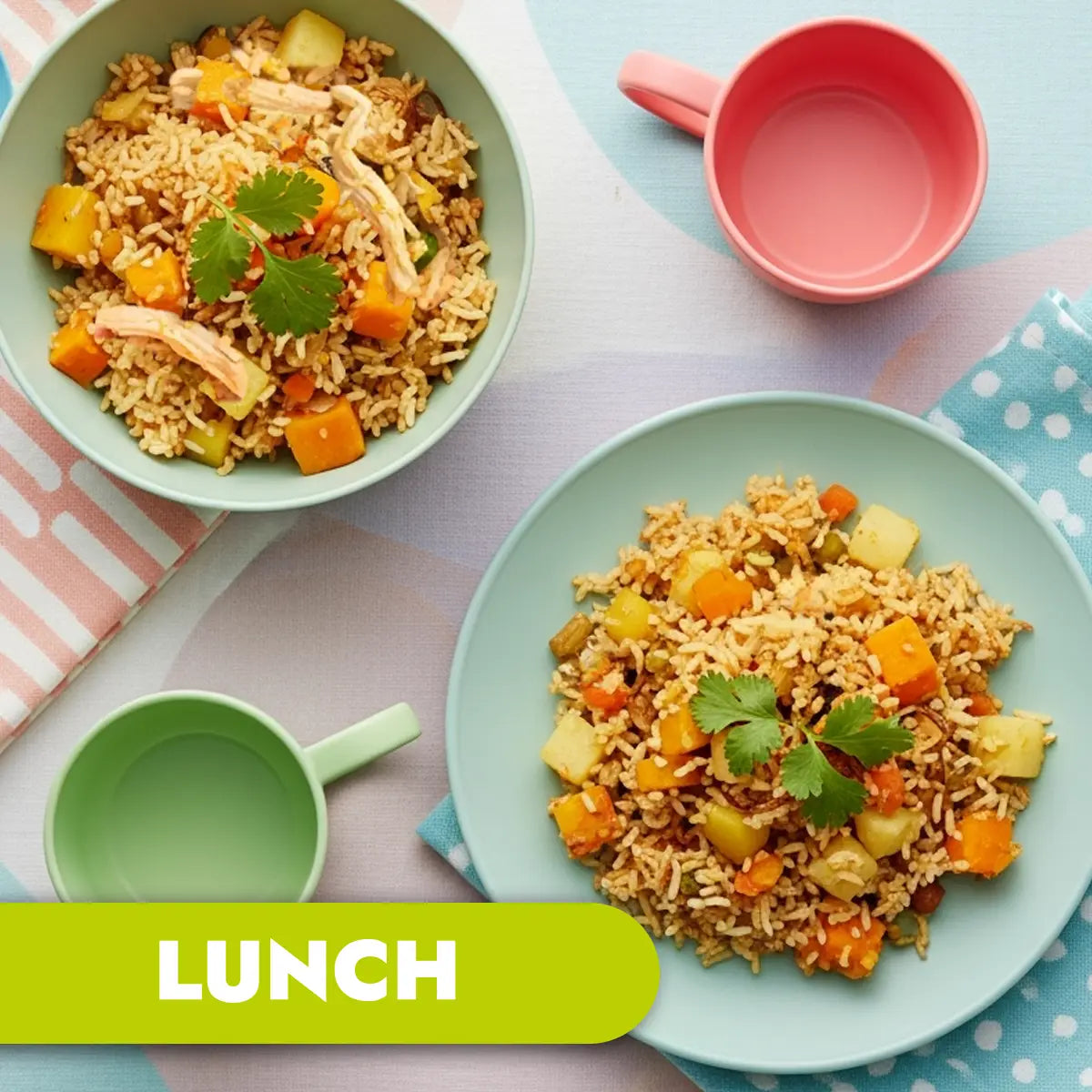 Two bowls of biryani rice dishes with vegetables on a colorful tablecloth, labeled 'LUNCH'.