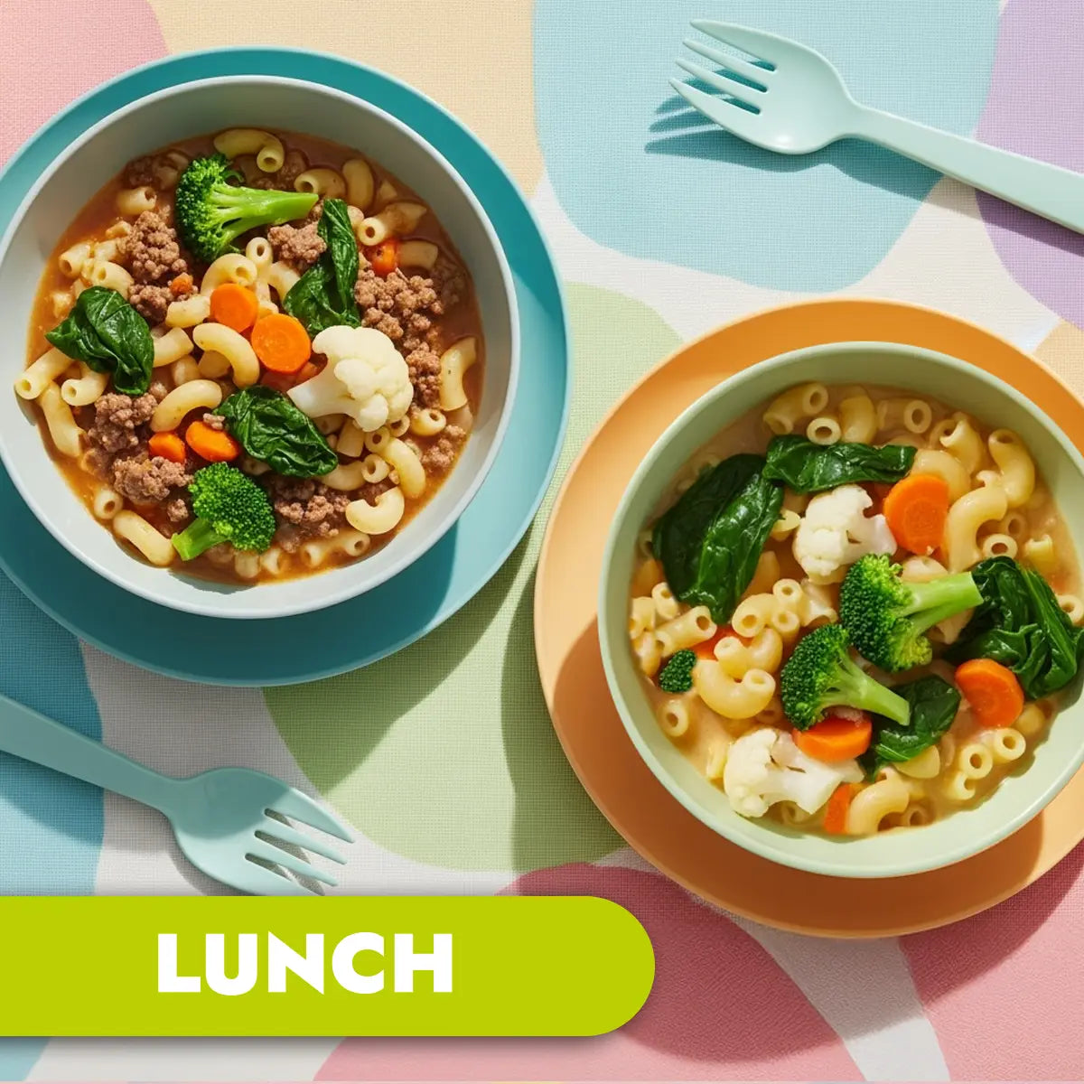 Two bowls of macaroni pasta with vegetables on a colorful tablecloth, labeled 'LUNCH'.