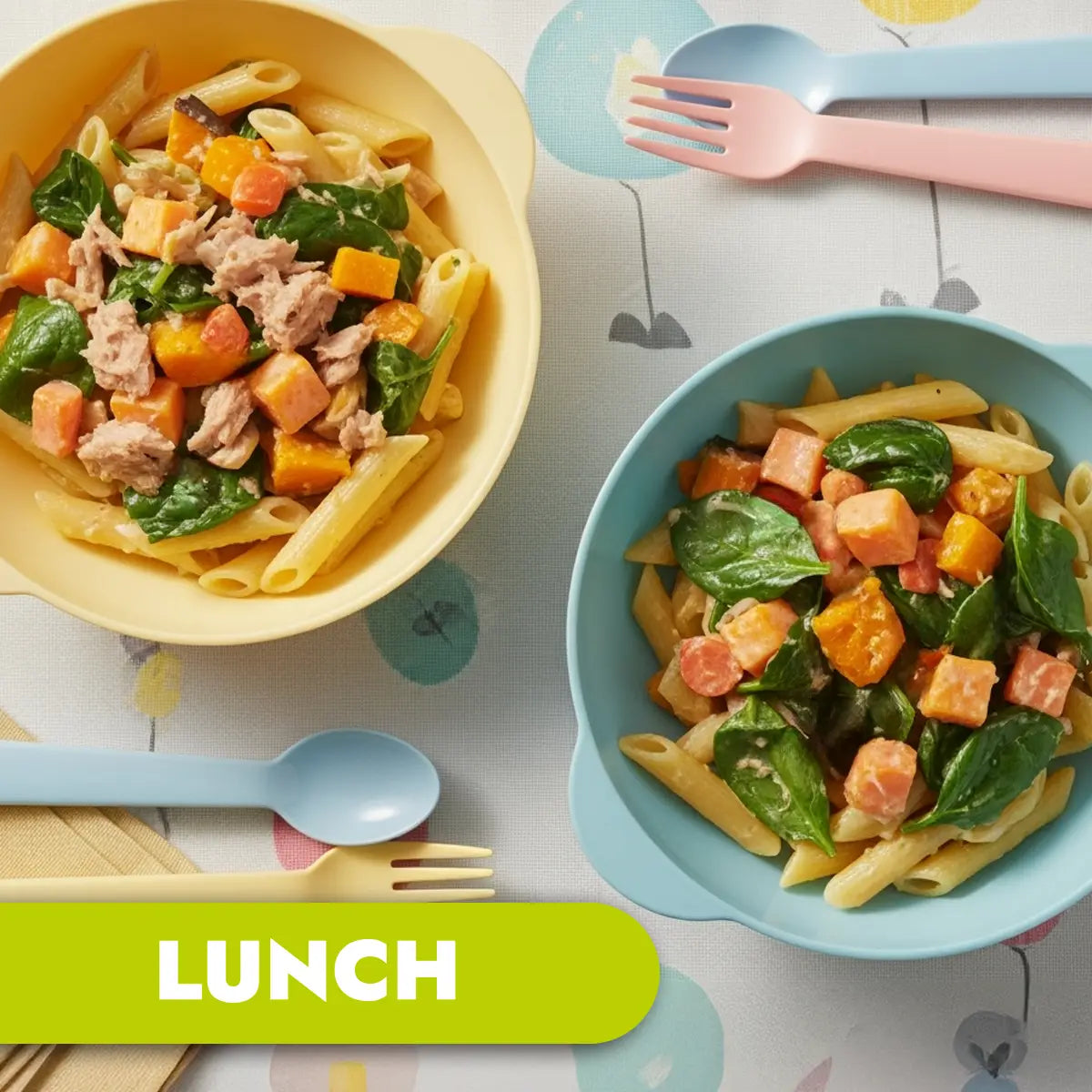 TLG Childcare catering. Two bowls of pasta with vegetables and tuna, accompanied by utensils on a patterned tablecloth, labeled 'LUNCH'.